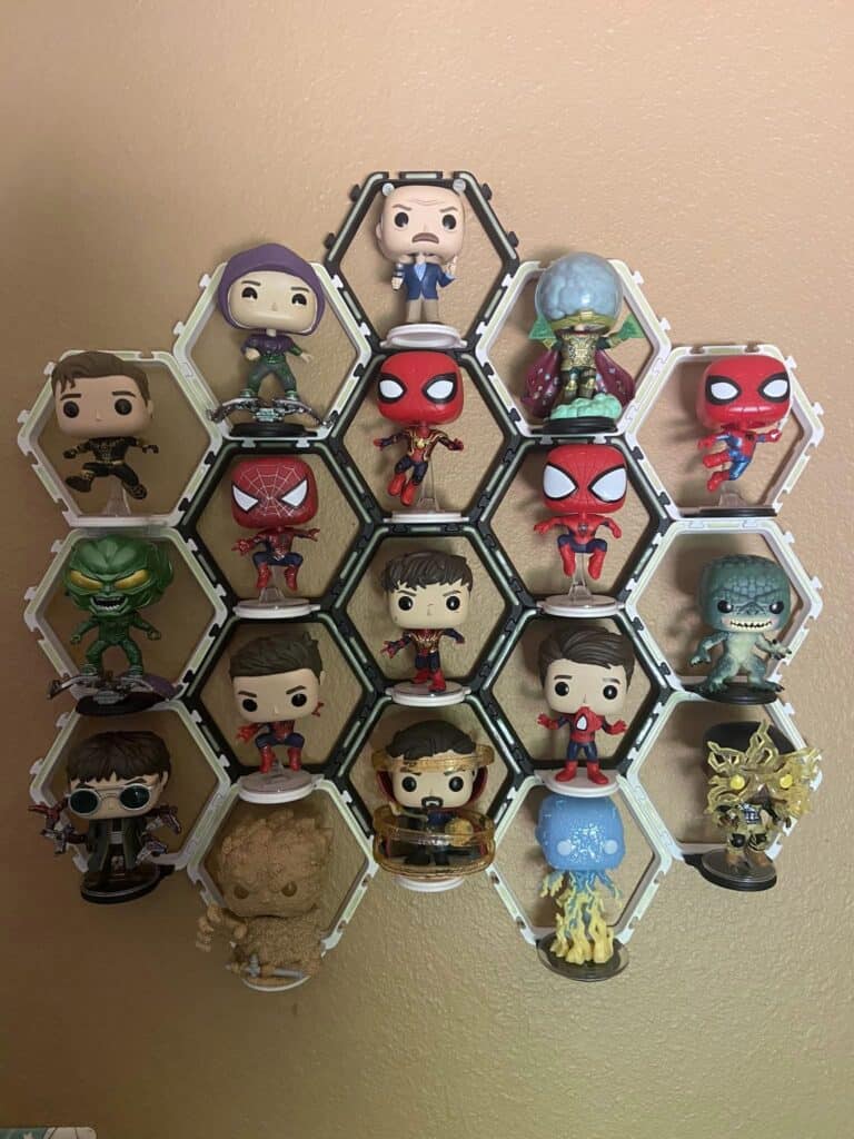 funko pop displayed in a hexagonal display stands on the wall