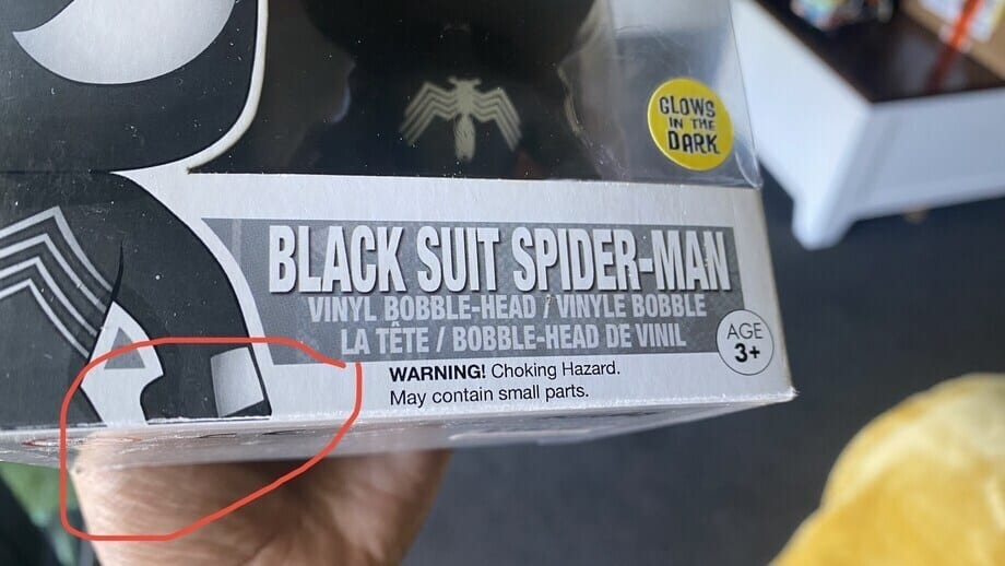 bottom part of black suit spiderman funko pop showing damages