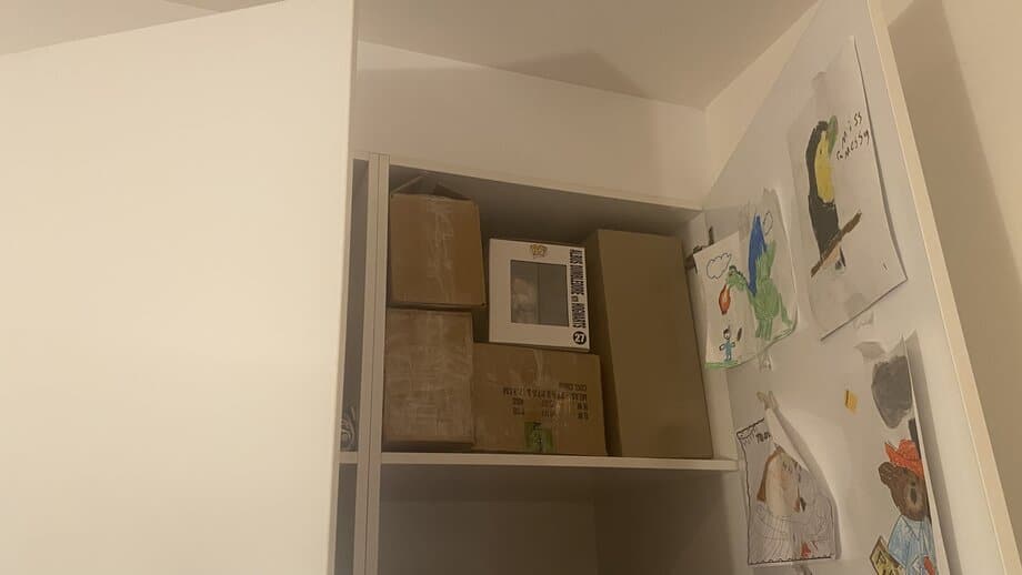 funko pop and shipping boxes inside a white closet